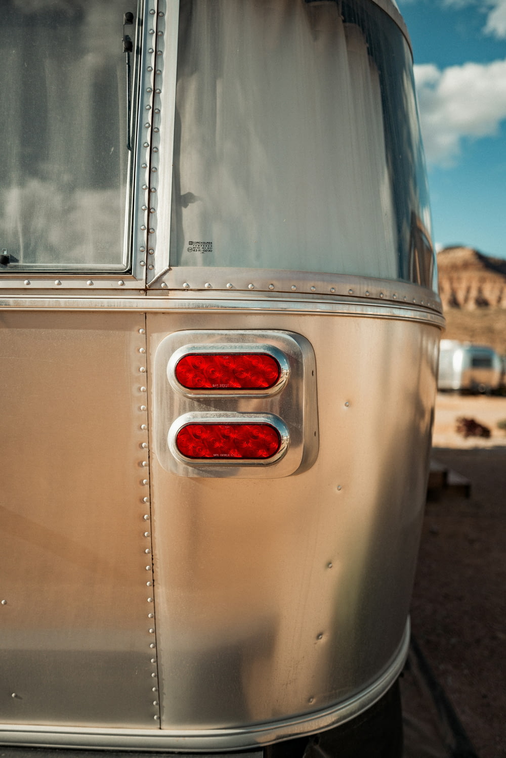 the tail lights of an old camper in the desert