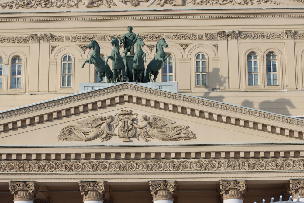 a large building with statues on top of it