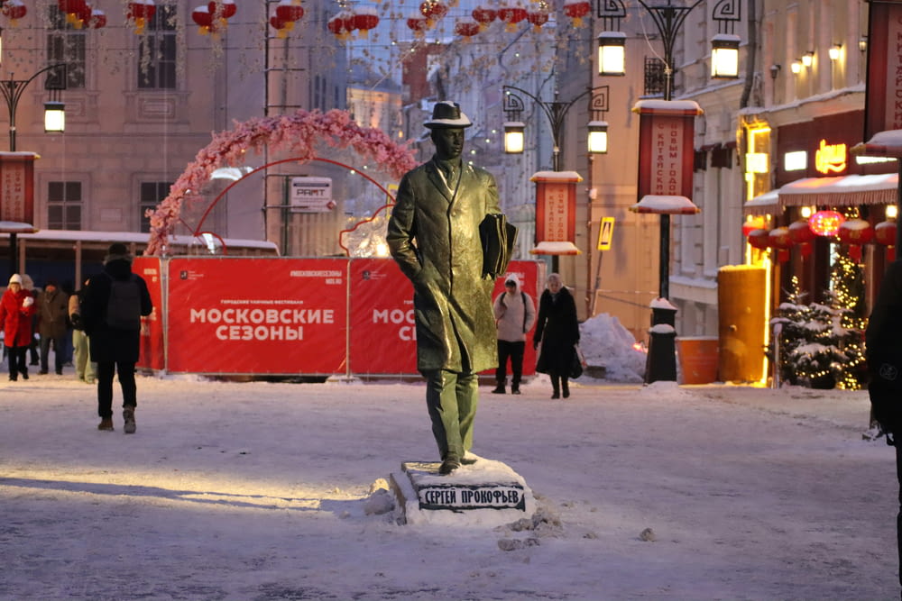 a statue of a man standing in the snow