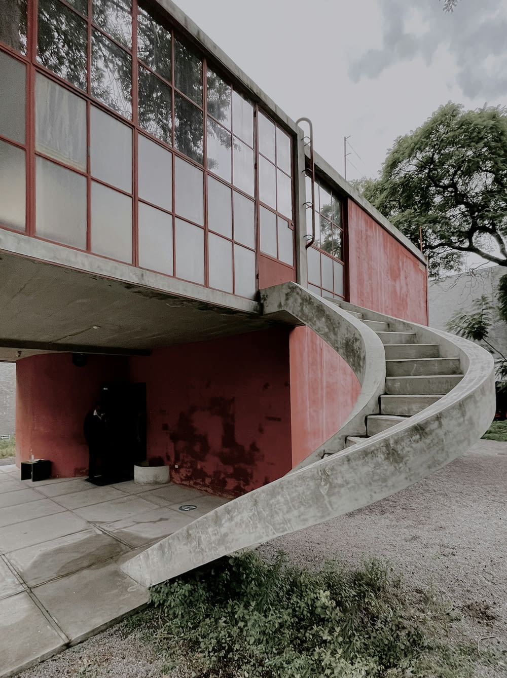 a concrete staircase leading to a red building