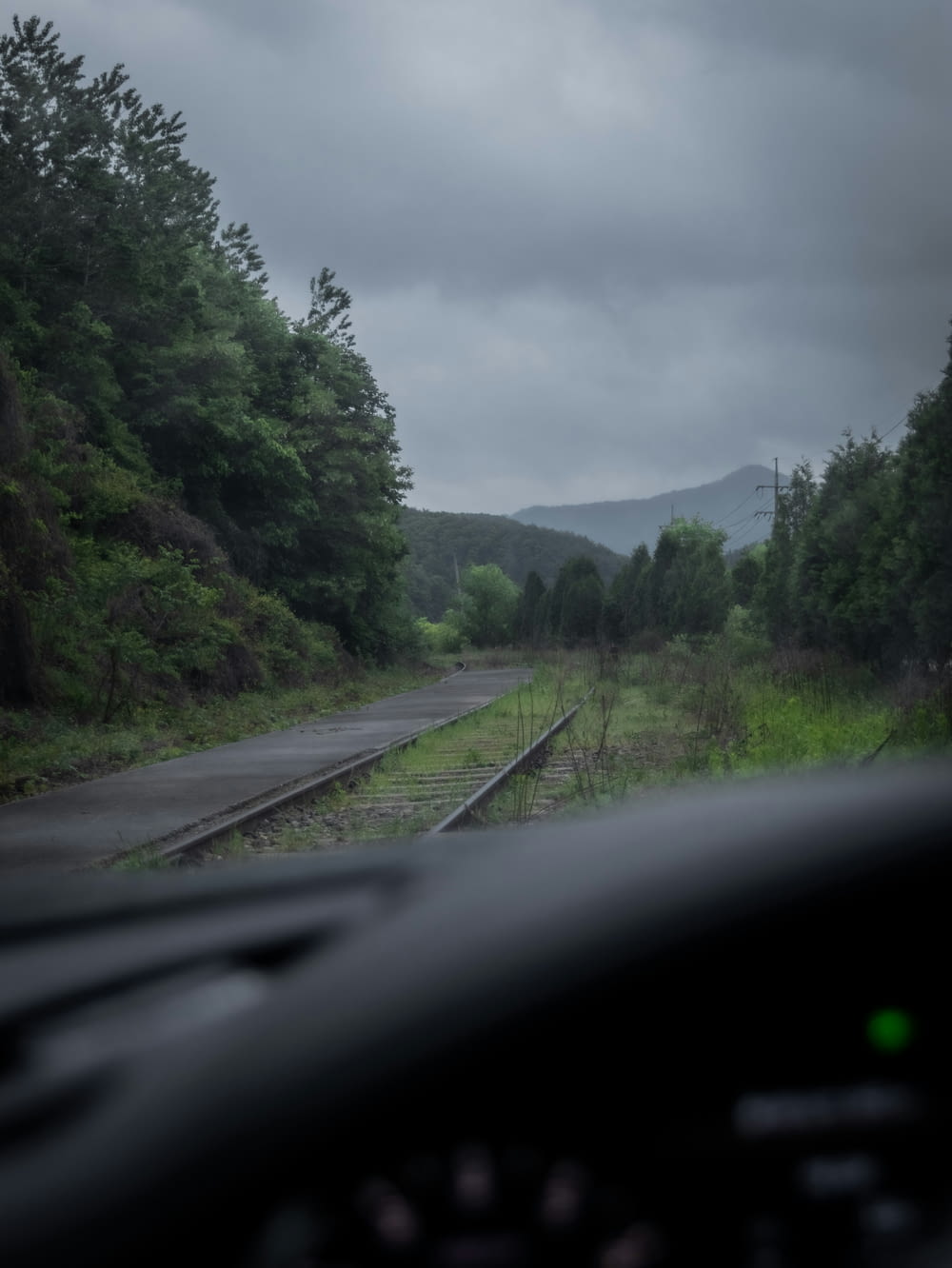 a view of a train track from inside a car