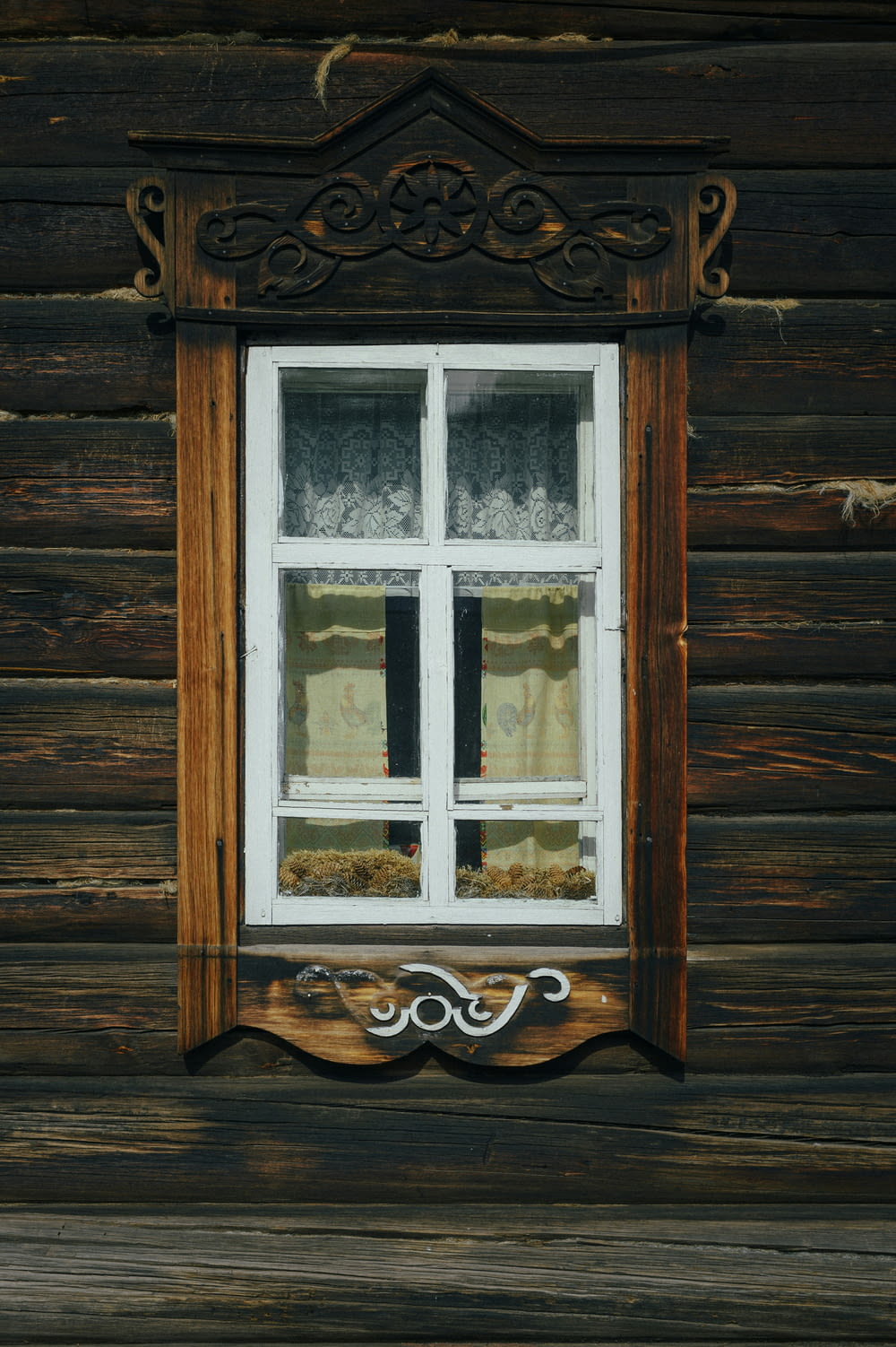 a window on a wooden wall with a window sill