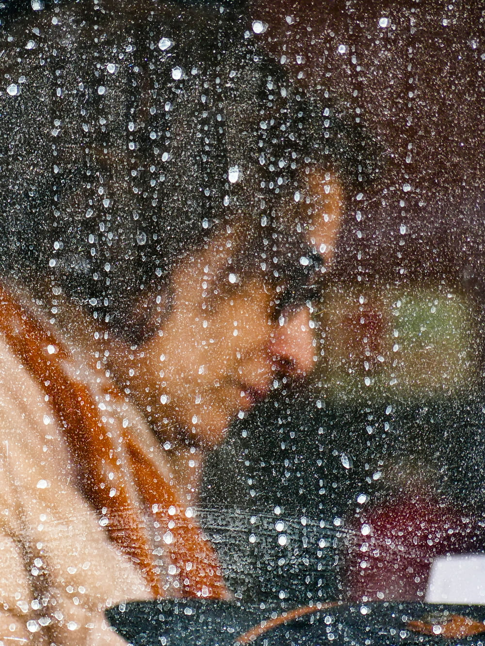 a woman looking at her laptop in the rain