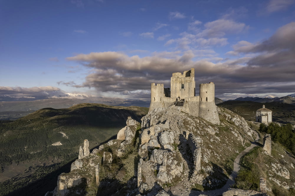 a castle sitting on top of a rocky mountain