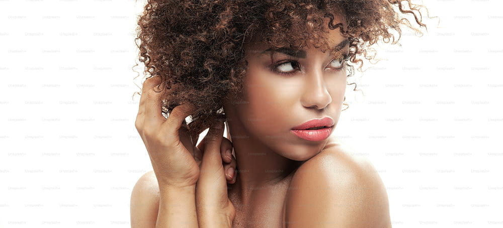 Beauty closeup portait of young  african american girl with afro. Ideal skin.