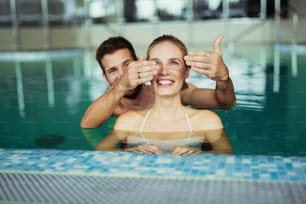 Romantic couple enjoying thermal bath spa and wellness center