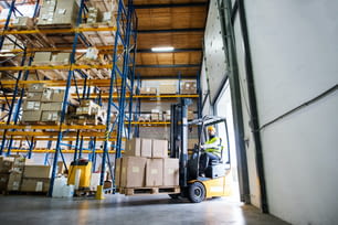Man forklift driver working in a warehouse.Man forklift driver working in a warehouse.