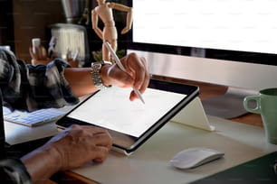 Cropped shot of designer sketch graphic drawing on digital display tablet creative  at workplace