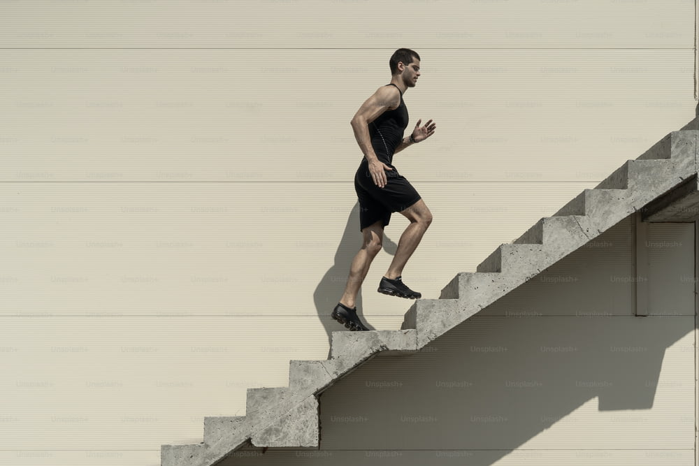 Ambitions concept with sportsman climbing stairs, running.