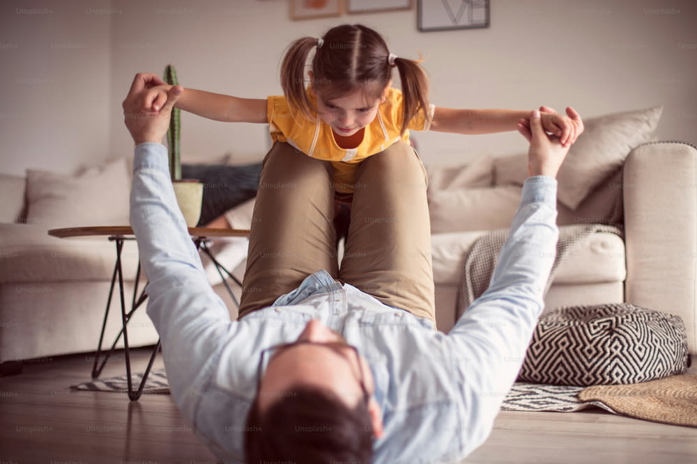 Making every moment together count.  Father and daughter having fun at home.