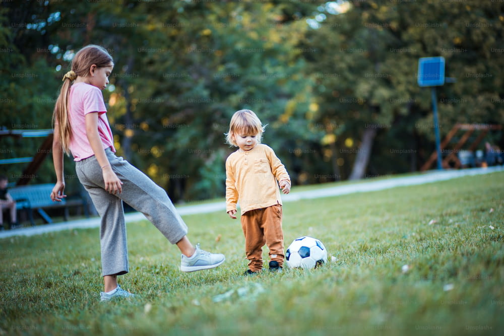 Sister and brother playing football.