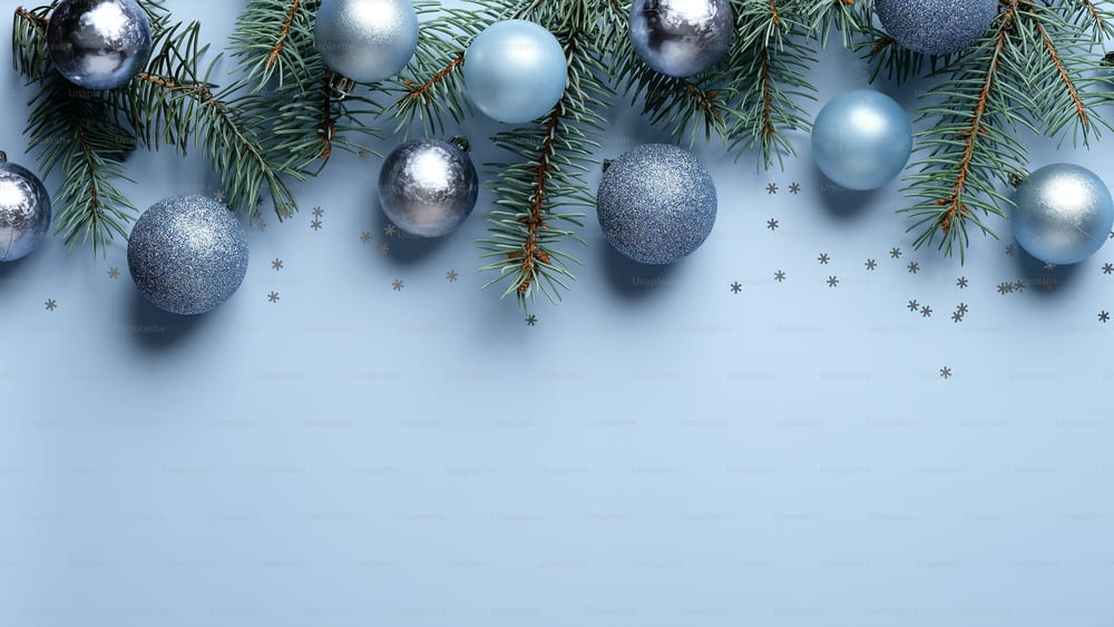 Christmas banner mockup. Flat lay, top view blue and silver balls decoration with pine tree branches on pastel blue background. Christmas, New year, winter holiday celebration concept.