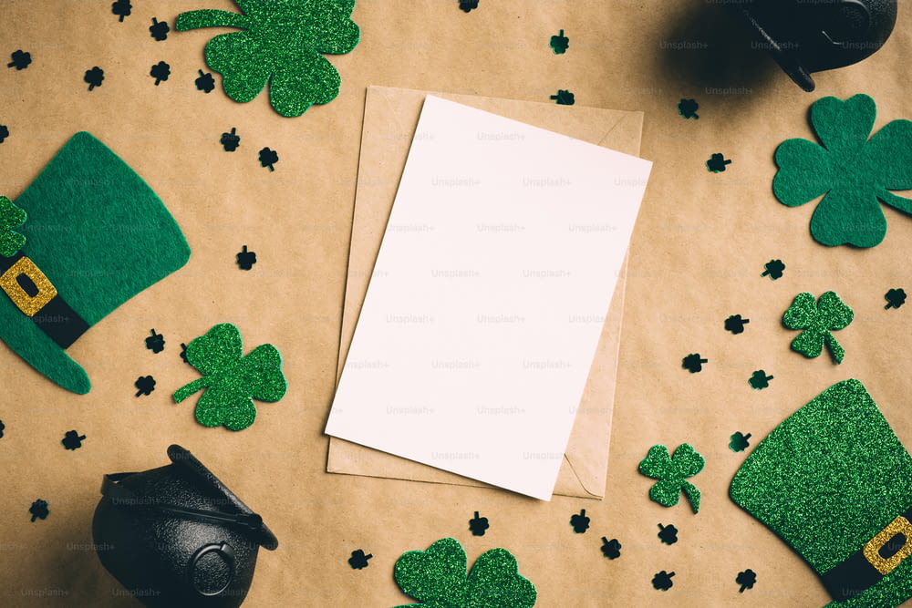 St Patrick's Day banner design. Blank paper card, Irish elf hats, pots of gold, shamrock clover leaves on kraft paper background. Happy Saint Patrickâs Day concept. Vintage, retro style.