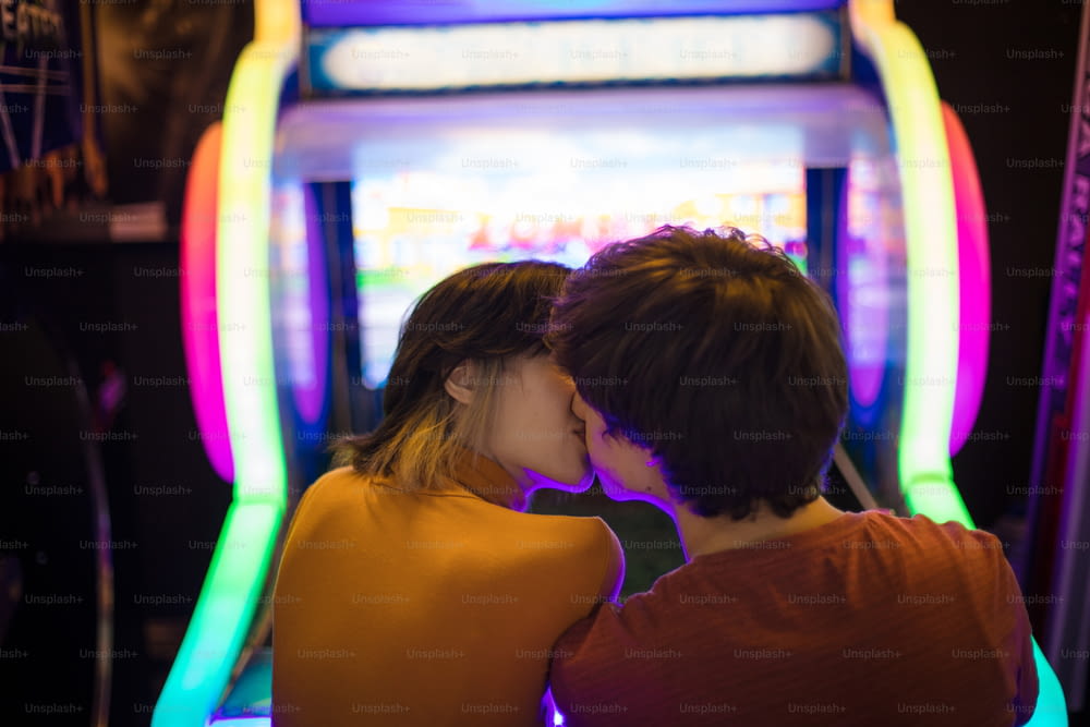 Couple having fun in playroom. Playing a games. The couple is kissing.