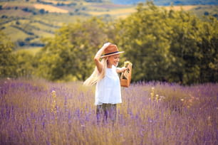 Young smiling Caucasian beautiful woman in lavender field.