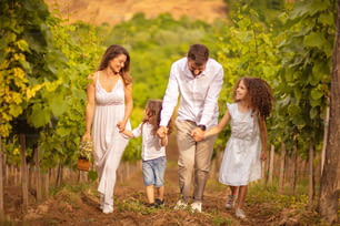 Family walking trough vineyard.