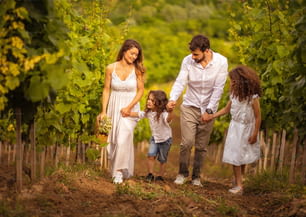 Family walking trough vineyard.  Time for walk.