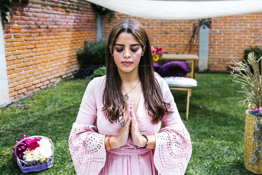 Portrait of latin girl meditating with closed eyes in holistic therapy session