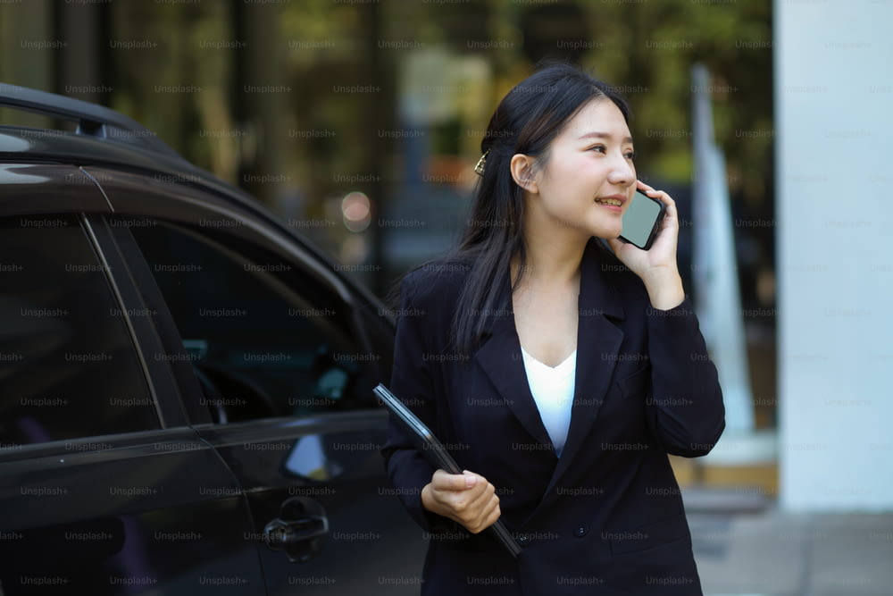 Successful businesswoman on the street while talking on the phone with business client. urban business life concept.