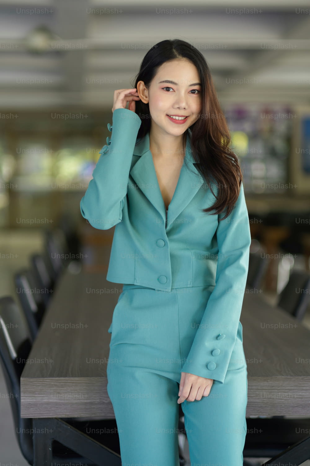 Portrait of Beautiful Asian young business woman in stylish suit standing in the board room.
