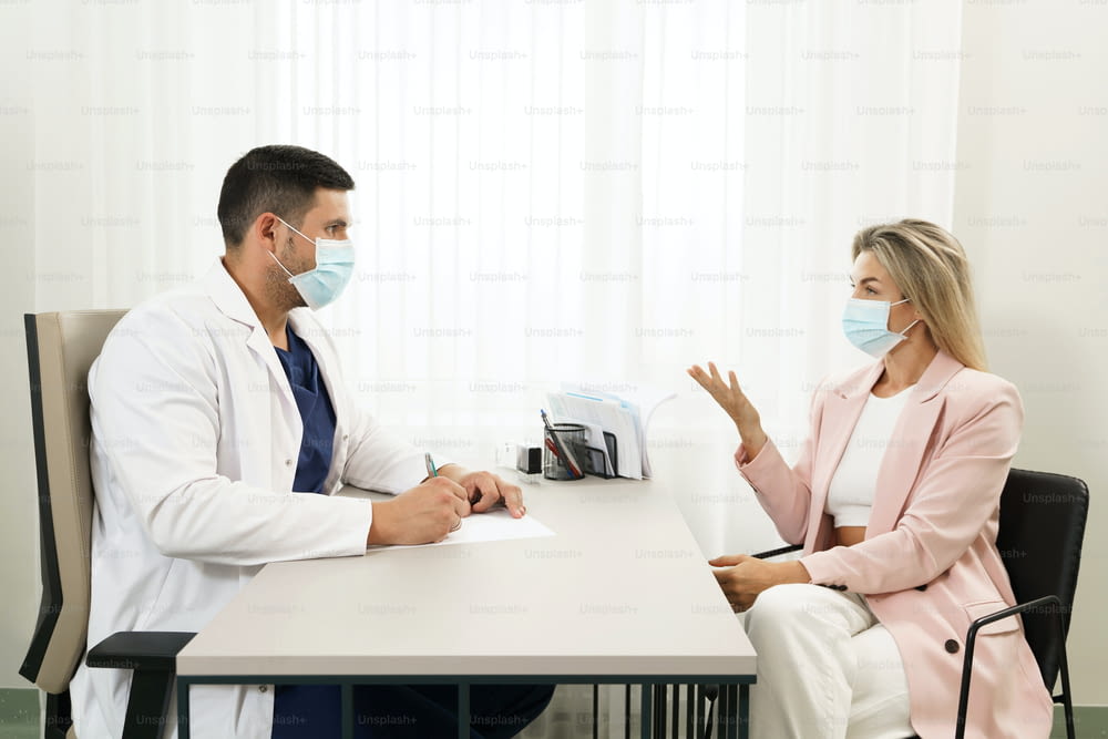 Doctor and female patient during consultation in office