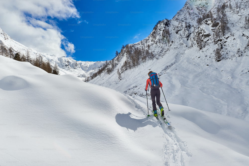 Girl makes ski mountaineering uphill alone in the alps