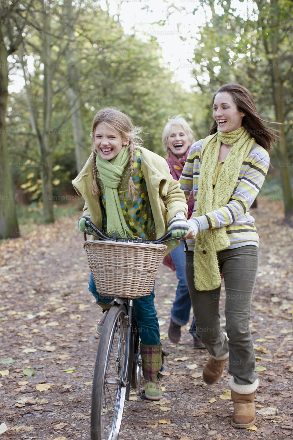 three girls riding a bike in the woods