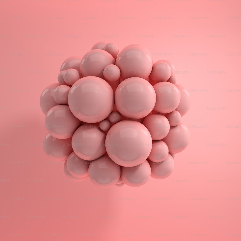 Rendu 3D de sphères polies flottantes sur fond rose. Composition géométrique abstraite. Groupe de boules aux couleurs pastel roses avec des ombres douces