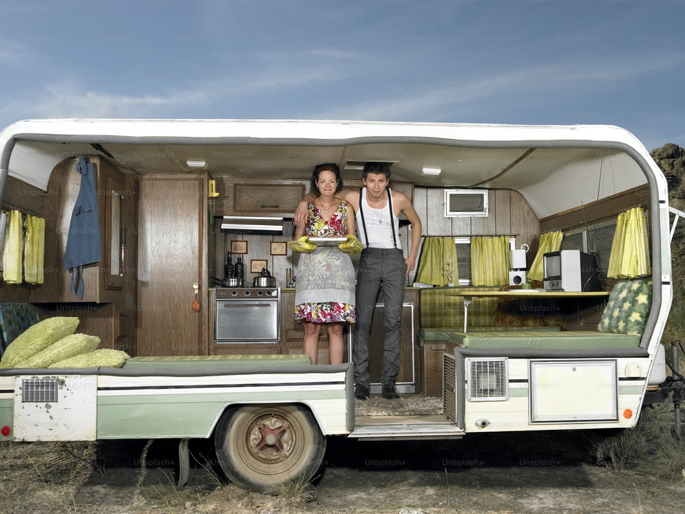a man and a woman standing in the back of a trailer