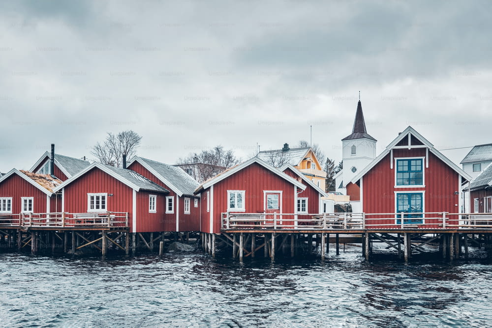 Traditional red rorbu houses in Reine fishing village in winter. Lofoten islands, Norway