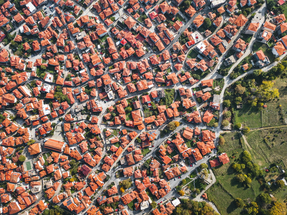 Aerial drone view above the traditional red roofs of a resort town or village. The concept of real estate and travel in Europe