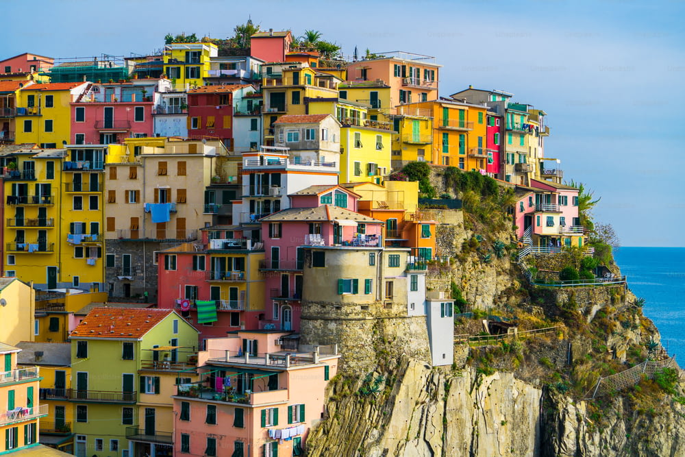 Colorful houses in Manarola Village, Cinque Terre Coast of Italy. Manarola is a beautiful small town in the province of La Spezia, Liguria, north of Italy and one of the five Cinque terre attractions.