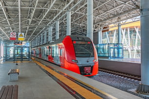 Passenger commuter train on station platform awaiting passengers