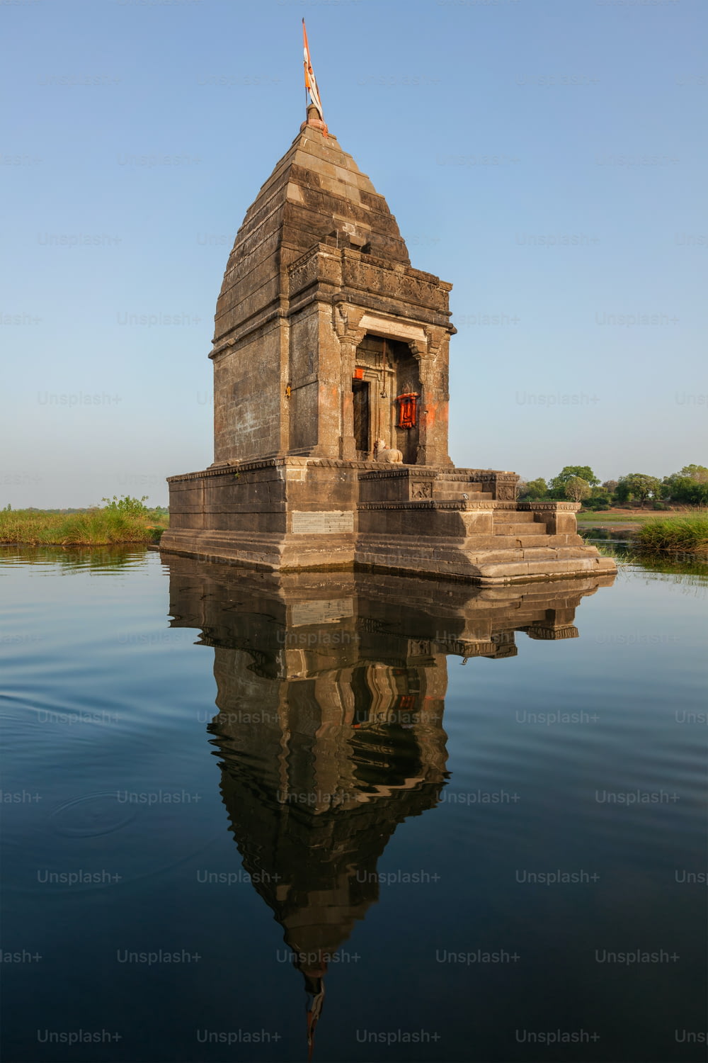 Baneswar temple (Small Hindu temple dedicated to Shiva) in the middle of the holy Narmada River, Maheshwar, Madhya Pradesh state, India