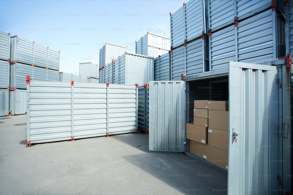Modern cargo storage area with metal container, open spacious container with stack of boxes