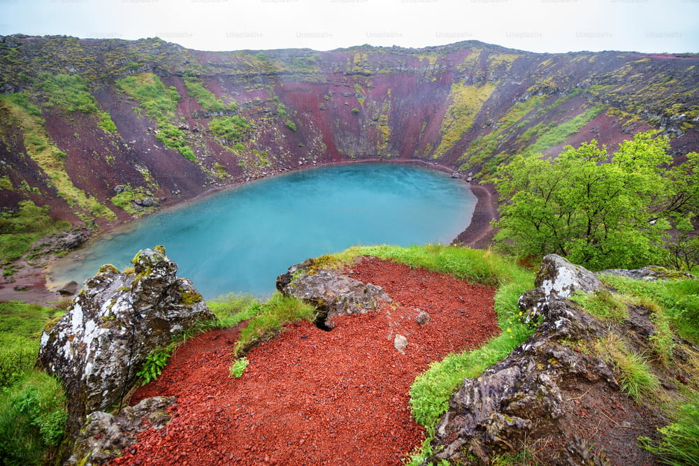 Volcano crater with a turquoise lake inside, Iceland landscape.