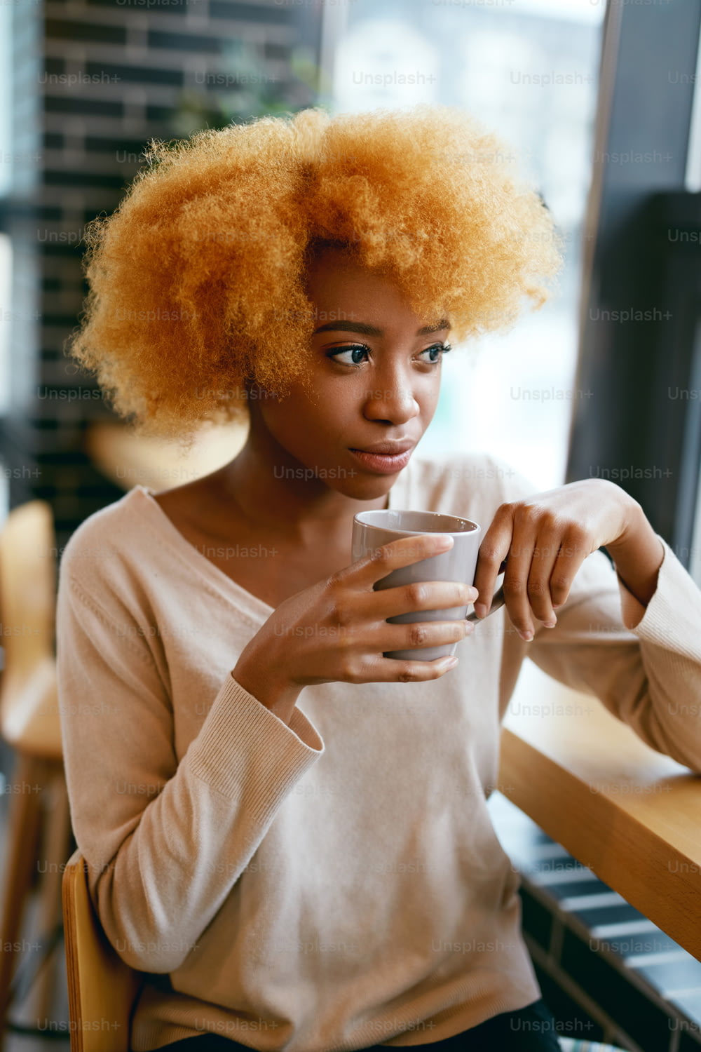 Beautiful Girl Drinking Coffee Drink In Cafe Near Window. Portrait Of Young Smiling African Woman In Casual Clothes With Cu0p Of Hot Beverage In Cafe. High Resolution