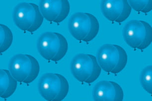 a group of blue balloons floating in the air
