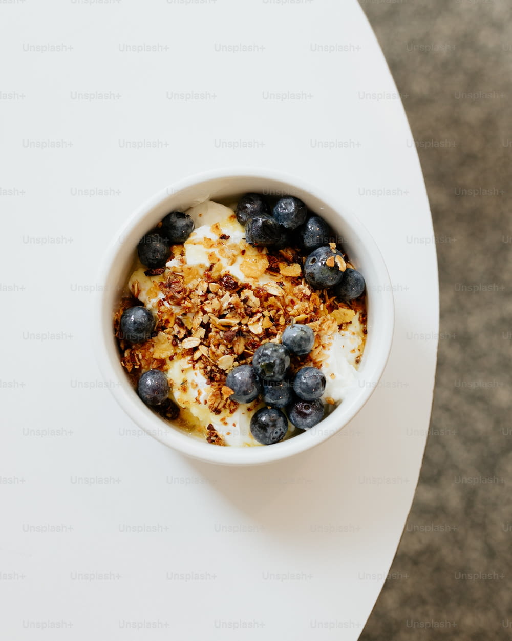 a bowl of yogurt with blueberries and granola