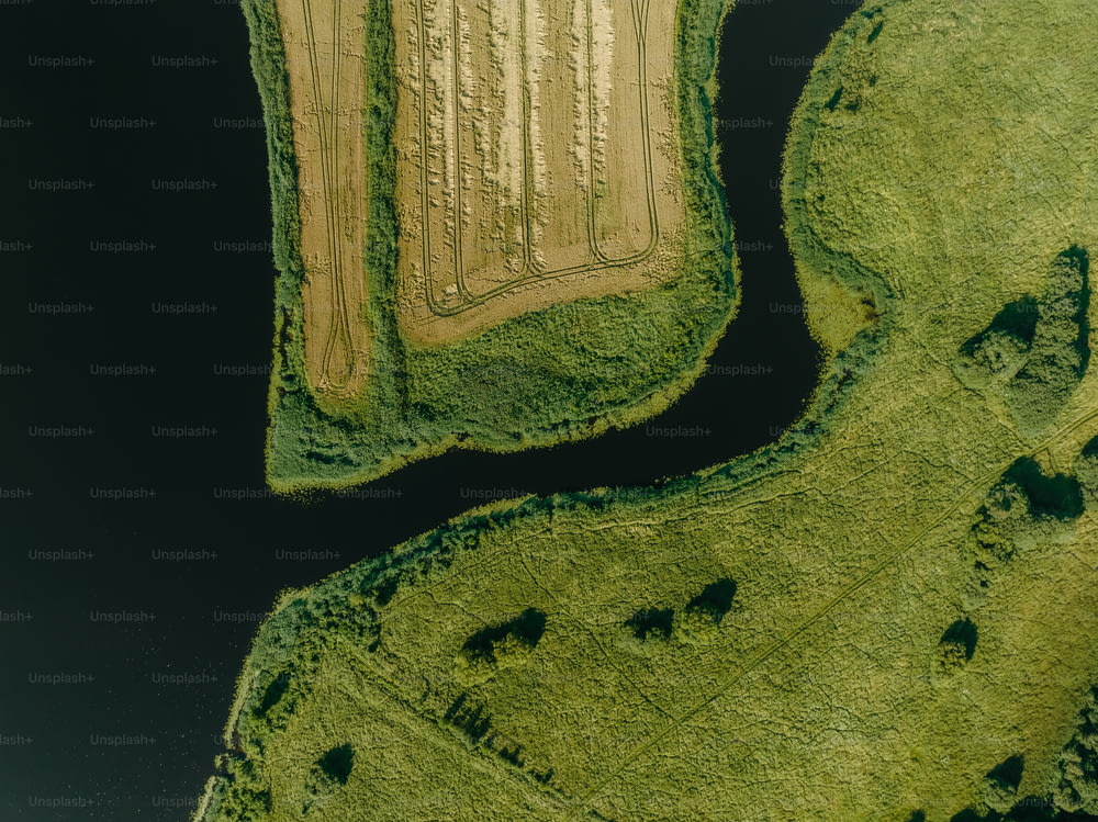 an aerial view of a field and a river