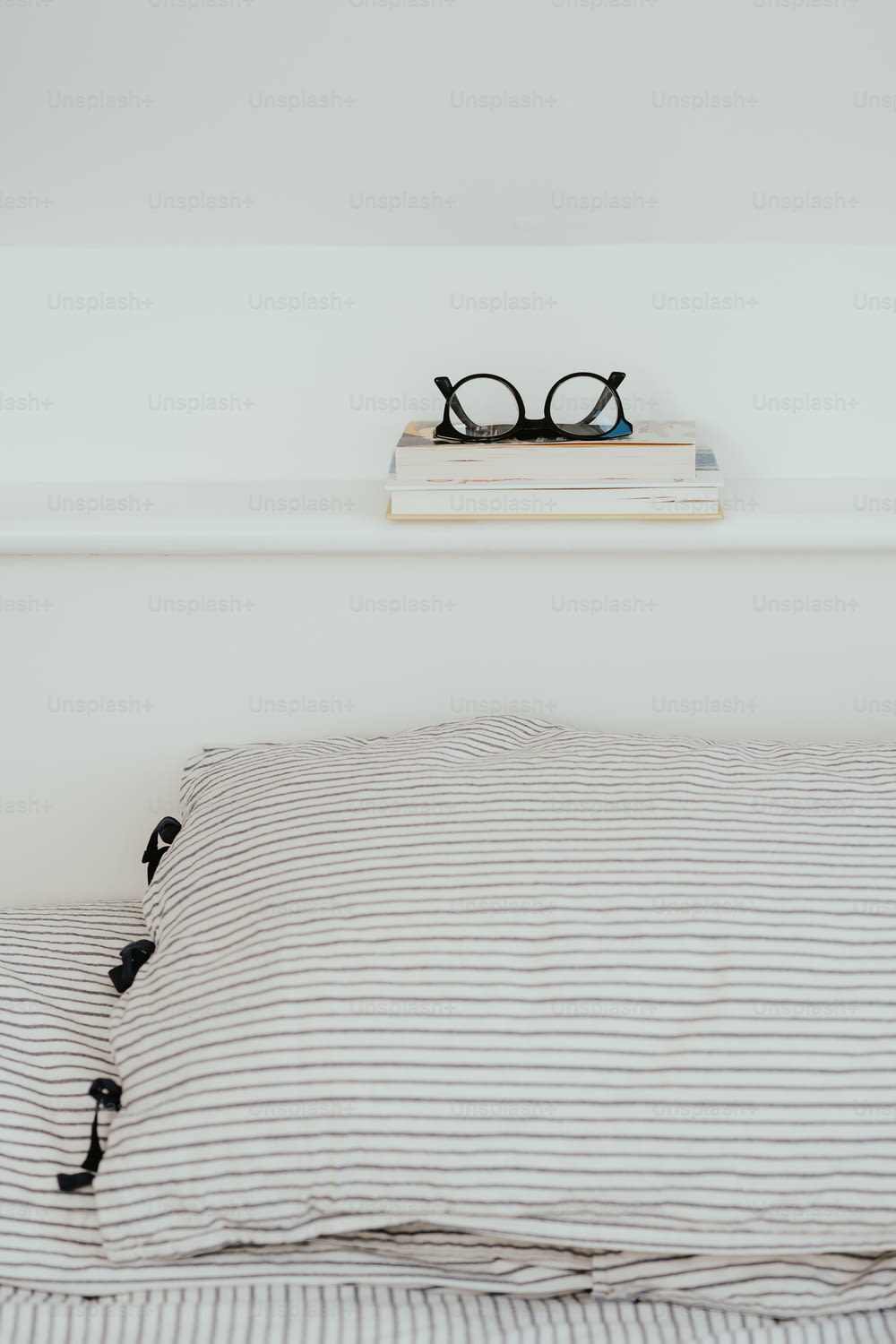 a pair of glasses sitting on top of a bed