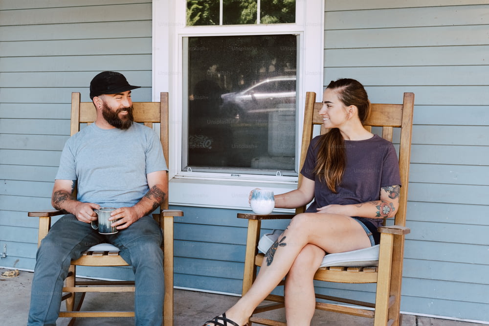 a man sitting next to a woman on a porch