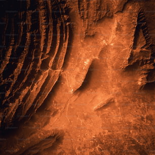 a red and black photo of a rock formation