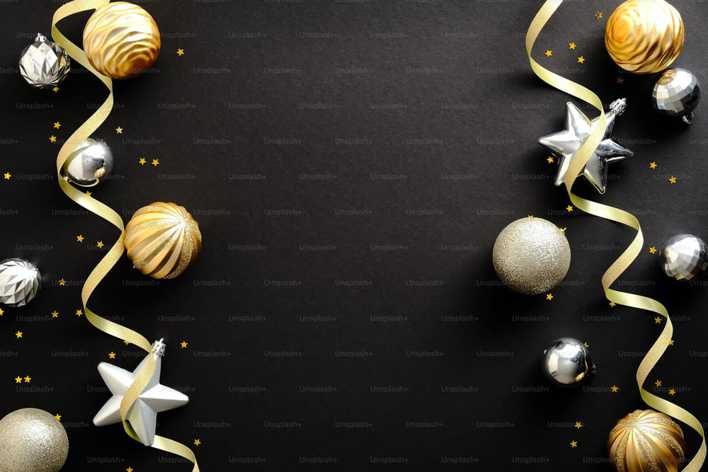 Merry Christmas and Happy New Year greeting card design. Christmas golden and silver ornaments on black background. Top view. Festive Christmas frame, banner mockup.