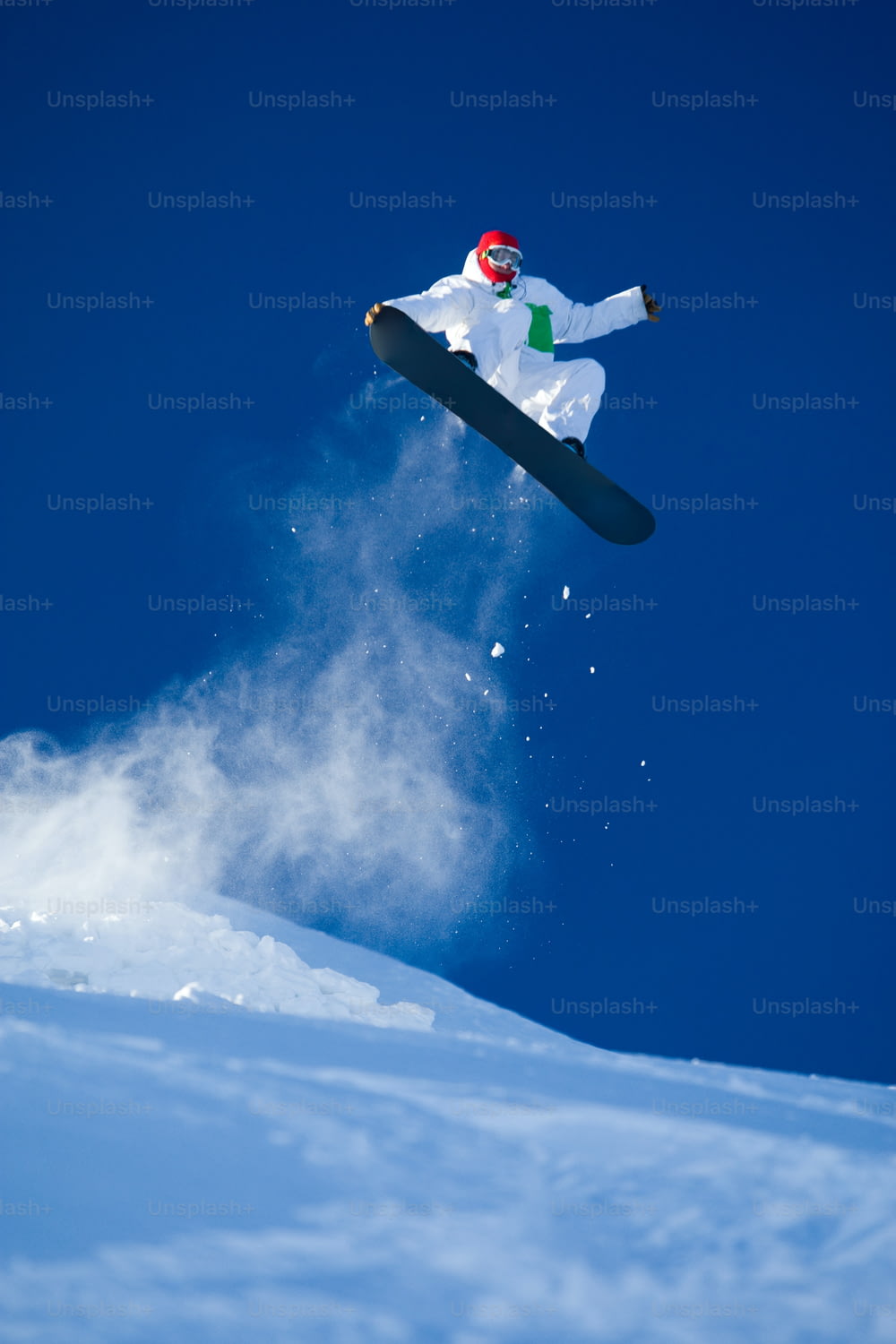 Photo of brave sportsman jumping on snowboard over blue sky