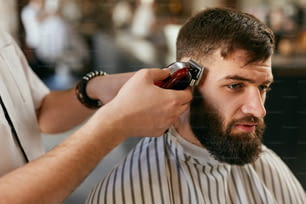 Barber Shop Men Hair Cut. Barber Doing Men Fashion Hairstyle, Cutting Man's Hair With Trimmer. High Resolution