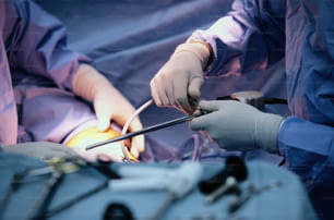 two surgeons are performing surgery on a patient