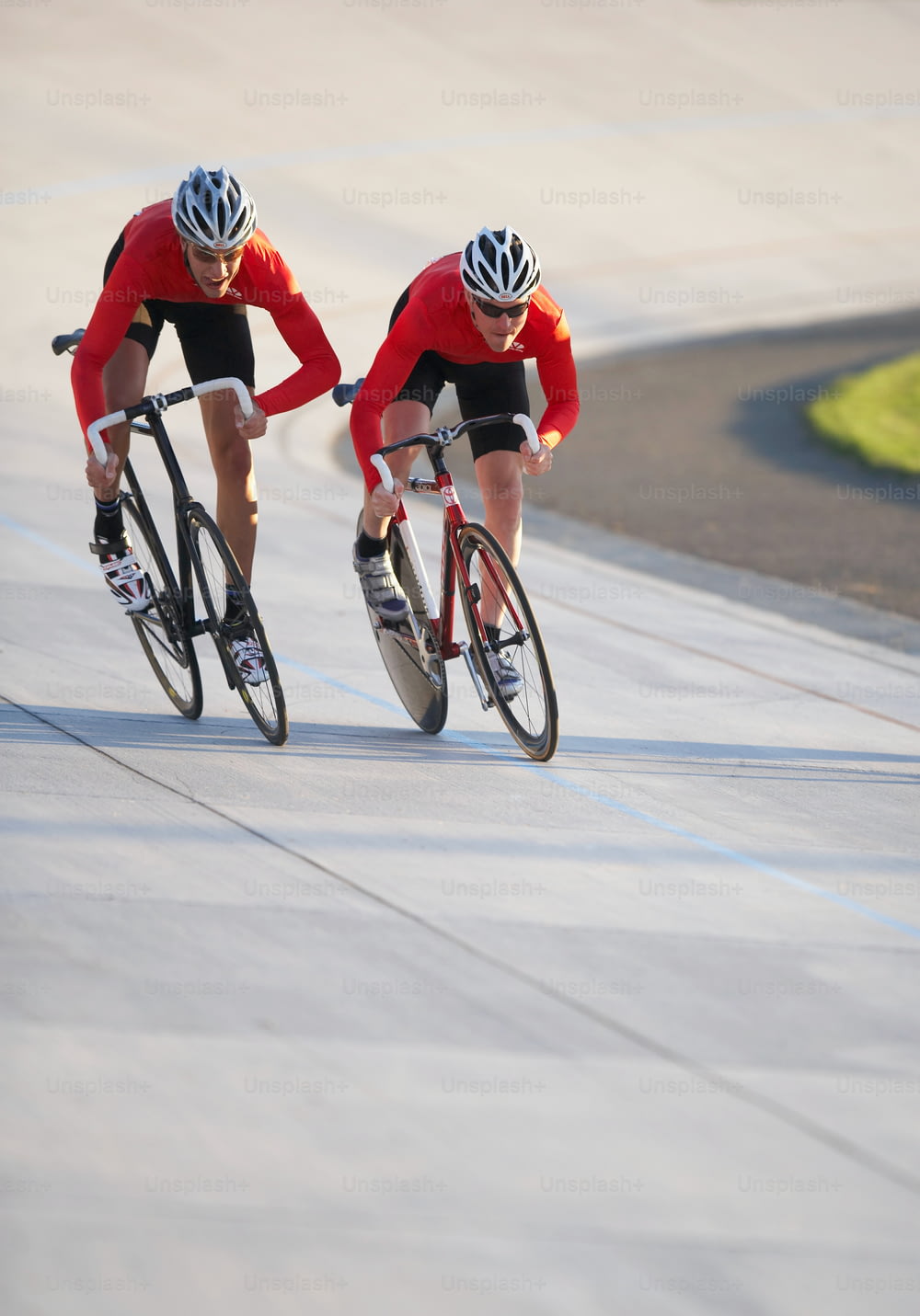 two bicyclists racing down a paved road