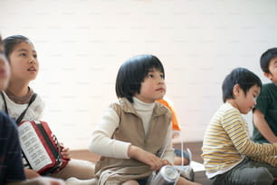a group of young children sitting next to each other