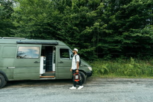 a man standing in front of a green van